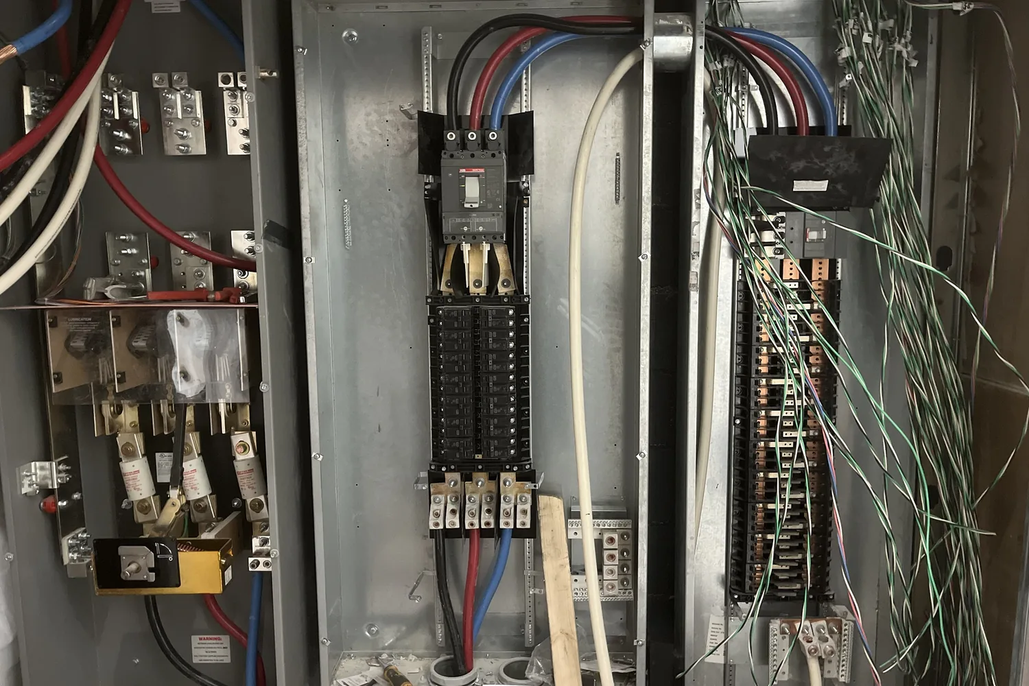 Inside a distribution panel: the main breaker, feeders and the breaker rows before the cover goes on